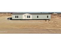 New manufactured home with a gray exterior and white trim on a desert lot at 2693 S 357Th Dr, Tonopah, AZ 85354