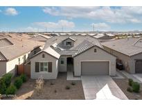 Single-story home with gray exterior, two-car garage, and landscaping at 2929 E Birdsong Ave, San Tan Valley, AZ 85143