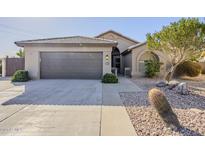 Single-story home with a two-car garage and desert landscaping at 2930 N 154Th Dr, Goodyear, AZ 85395