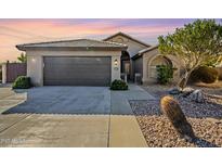 Single-story home with a two-car garage and desert landscaping at 2930 N 154Th Dr, Goodyear, AZ 85395