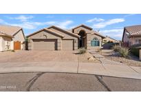 Charming single-story home with a well-manicured front yard and a three-car garage at 3106 E Hiddenview Dr, Phoenix, AZ 85048