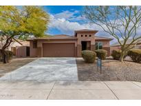 Single-story home with a two-car garage and landscaped front yard at 3663 S Hassett --, Mesa, AZ 85212