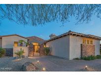 Spanish-style home with stone accents and a welcoming entryway at 9825 E Sharon Dr, Scottsdale, AZ 85260