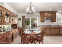 Bright dining area with wood table and hutch at 1417 S Grand Dr, Apache Junction, AZ 85120