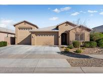 Single-story home with two-car garage and landscaped front yard at 24211 N 168Th Ln, Surprise, AZ 85387