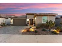 Single-story home with brown garage door and landscaped yard at 27453 W Wahalla Ln, Buckeye, AZ 85396