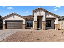 Charming single-story home with a low-maintenance desert-style front yard and stacked stone architectural features at 42104 N Golden Trl, San Tan Valley, AZ 85140