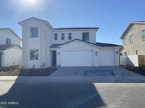 Two-story house with a three-car garage and landscaped front yard at 5025 W Beryl Ave, Glendale, AZ 85302