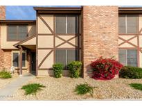 Brick townhouse exterior with landscaping and walkway at 7905 W Thunderbird Rd # 309, Peoria, AZ 85381