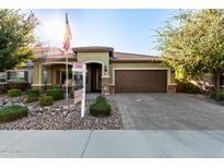 Single-story home with brown garage door, landscaping, and a paved driveway at 11047 E Tupelo Ave, Mesa, AZ 85212