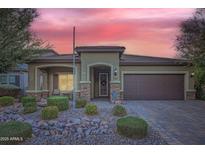 Single-story home with attractive landscaping and a two-car garage at 11047 E Tupelo Ave, Mesa, AZ 85212