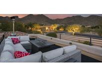 Relaxing rooftop terrace with sectional seating, fire pit, and mountain views at 12067 N 135Th Way, Scottsdale, AZ 85259