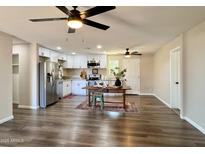 Remodeled kitchen features white cabinets, stainless steel appliances, and granite countertops at 1325 W 7Th Ave, Mesa, AZ 85202