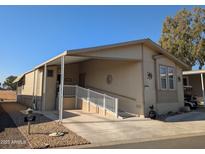 Tan mobile home with carport and ramp access at 17200 W Bell Rd # 1599, Surprise, AZ 85374