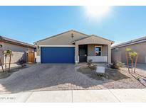 New single-story home with blue garage door and landscaped yard at 17645 W Jackson St, Goodyear, AZ 85338