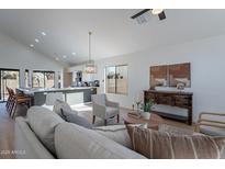 Bright living room features vaulted ceilings, hardwood floors, and neutral color palette at 2513 N 90Th Ln, Phoenix, AZ 85037