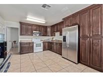 Bright kitchen with stainless steel appliances and ample wood cabinetry at 2738 N 40Th Dr, Phoenix, AZ 85009