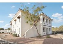 Two-story building with Spanish-style architecture and a landscaped courtyard at 2950 W Louise Dr # 203, Phoenix, AZ 85027