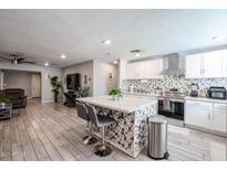 Open concept kitchen with island and modern appliances at 3440 W Krall St, Phoenix, AZ 85017