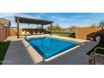 Inviting rectangular pool with pergola and lounge chairs at 5629 S Veneto --, Mesa, AZ 85212
