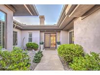 Inviting entryway with a courtyard and lush landscaping at 7462 E Visao Dr, Scottsdale, AZ 85266