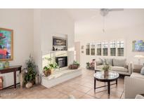 Bright living room with fireplace, tile floors, and comfy seating at 7800 E Lincoln Dr # 2092, Scottsdale, AZ 85250