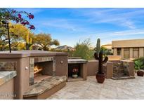 Outdoor patio with fireplace, seating, and mountain views at 9270 E Thompson Peak Pkwy # 335, Scottsdale, AZ 85255