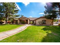 Beautiful home with landscaped yard and large driveway at 9613 W Camino De Oro Dr, Peoria, AZ 85383