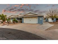 Two-car garage and nicely landscaped front yard at 10611 W Caron Dr, Sun City, AZ 85351