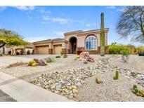 Desert landscape, two-car garage, and a charming exterior at 11329 E Diamond Cholla Dr, Scottsdale, AZ 85255