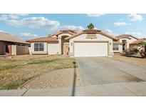 Single-story house with a two-car garage and well-maintained front yard at 12558 W Holly St, Avondale, AZ 85392