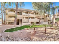 Two-story condo building with landscaping and a grassy area at 1331 W Baseline Rd # 316, Mesa, AZ 85202