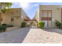 La Fuente Condominiums exterior showing building entrance and paved pathway at 1701 W Tuckey Ln # 218, Phoenix, AZ 85015