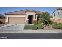 Single-story house with a two-car garage and well-manicured landscaping at 20226 N 260Th Dr, Buckeye, AZ 85396
