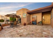 Inviting patio with seating area, tile flooring, and pergola at 25836 N Primo Cir, Rio Verde, AZ 85263