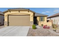 New single-story home with a two-car garage and desert landscaping at 3244 W Cedar Ridge Rd, Phoenix, AZ 85083