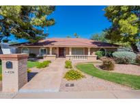 Beautiful ranch-style home with a well-manicured lawn and walkway at 4226 E North Ln, Phoenix, AZ 85028