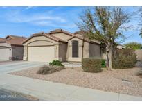 Single-story house with a two-car garage and desert landscaping at 42414 W Chambers Dr, Maricopa, AZ 85138