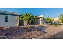 Mid-century modern home with carport and landscaped yard at 8642 E Monterosa Ave, Scottsdale, AZ 85251