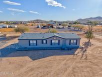 Single-level manufactured home with a large yard, situated on a spacious lot at 10991 W Hilltop Dr, Casa Grande, AZ 85193