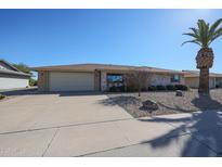 Brick ranch home with a two-car garage and mature landscaping at 12619 N Sun Valley Dr, Sun City, AZ 85351