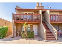 Attractive condo building with a private balcony and stairs at 14203 N 19Th Ave # 1051, Phoenix, AZ 85023