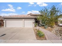 Attractive single-story home with a three-car garage and landscaped front yard at 1618 E Montoya Ln, Phoenix, AZ 85024