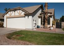 White stucco house with a two-car garage and desert landscaping at 1636 E Juanita Ave, Mesa, AZ 85204