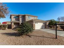 Two-story house with a neutral exterior, attached garage, and landscaping at 17840 W Calavar Rd, Surprise, AZ 85388