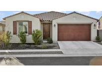 Single-story home with brown garage door and landscaping at 17855 W Thistle Landing Dr, Goodyear, AZ 85338