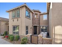 Tan two-story home with stone accents and a private patio at 21809 N 39Th St, Phoenix, AZ 85050