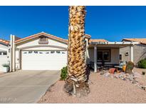 House exterior featuring a two-car garage, covered patio, and desert landscaping at 2329 N Recker Rd # 94, Mesa, AZ 85215