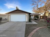 House exterior featuring a two-car garage and well-maintained landscaping at 2843 E Pershing Ave, Phoenix, AZ 85032