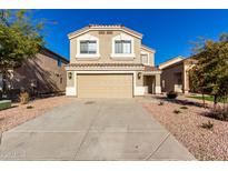 Two-story house with tan exterior, two-car garage, and landscaping at 3104 W Carlos Ln, San Tan Valley, AZ 85144